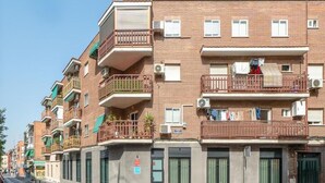 A multi-story residential building with balconies, air conditioning units, and a street view. - Dobo Madrid Moncayo (Madrid)