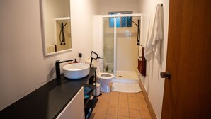 A bathroom with a sink, toilet, and shower.