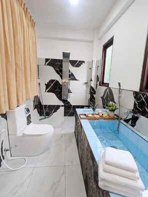 A modern bathroom with a marble shower, a bathtub, and a toilet. - ella dream mount (Ella)
