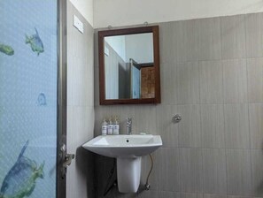 A bathroom with a white sink, a mirror, and tiled walls. - ella dream mount (Ella)