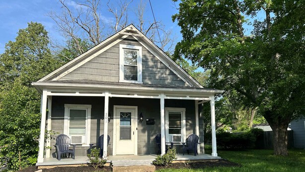 A single-story house with a porch, two front doors, and a small front yard. - Elm Corner, 2 bedroom family house in Historic Loveland (Loveland)