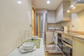 A modern kitchen with stainless steel appliances, a dishwasher, and a sink.
