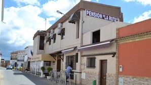 A building with a sign reading "PENSION 'LA RUTA'". - HOSTAL PENSION LA RUTA (Escacena del Campo)