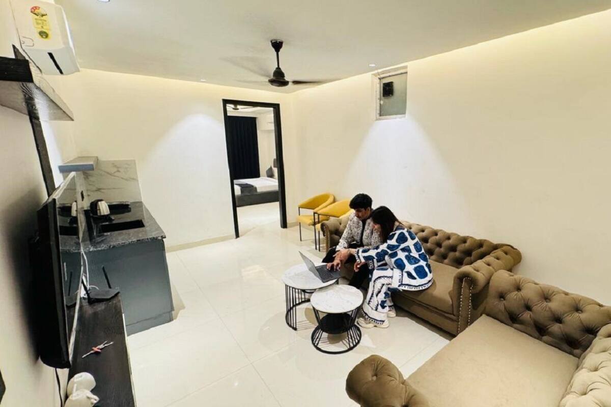 A modern living room with a sofa, a coffee table, and a TV.