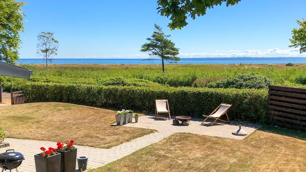 A patio with two lounge chairs, a barbecue grill, and flower planters. - Awesome home in Malling with WiFi (Malling)