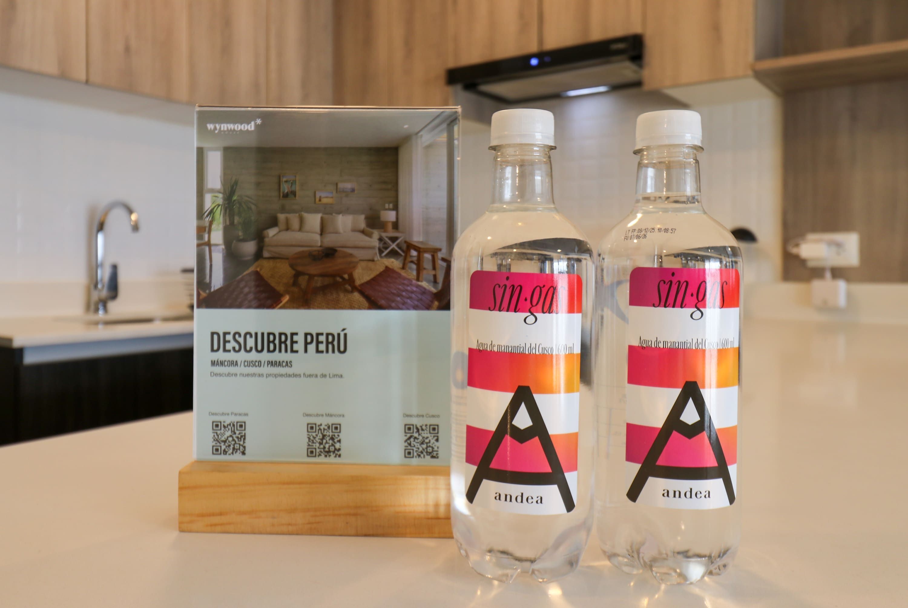Two bottles with labels and a box with a QR code.