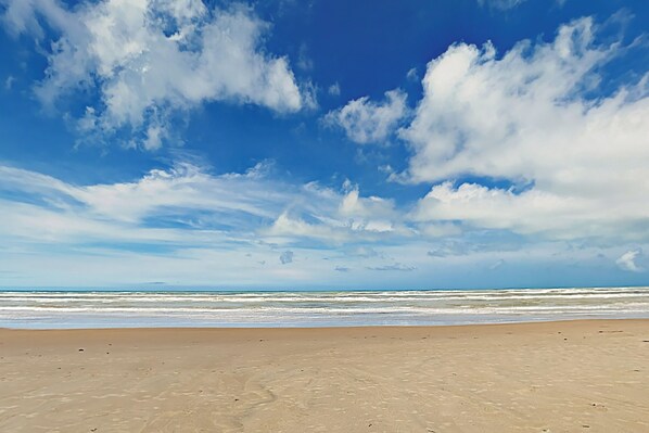 A beach with a clear sky and ocean waves. - 2BR w/ Patio, Luxury Perks: Suntide III - Unit 102 (South Padre Island)