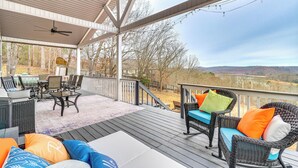 A covered deck with outdoor furniture, a ceiling fan, and a view of the landscape. - Mtn & Lake Norris Views: Family Home w/ Game Room! (La Follette)