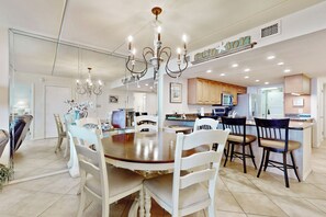 A spacious kitchen with a central island, white cabinetry, and a chandelier. - Resort Condo w/ Gulf Views: Suntide III - Unit 207 (South Padre Island)