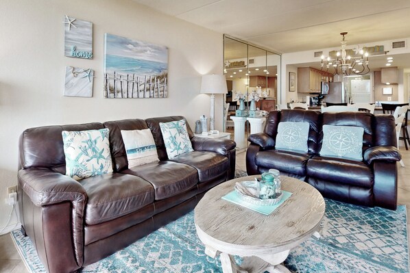 A living room with two brown leather sofas, a round coffee table, and a patterned rug. - Resort Condo w/ Gulf Views: Suntide III - Unit 207 (South Padre Island)