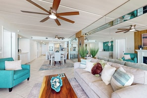 A spacious living area with a large sofa, a coffee table, and a dining area in the background. - Beachfront 2BR on 10th Fl: Suntide III - Unit 1004 (South Padre Island)