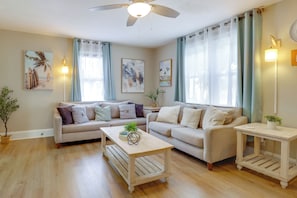 A living room with two sofas, a coffee table, and a side table.