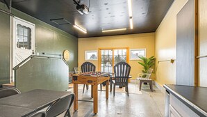 A room with a foosball table, chairs, a dining table, and a kitchen area. - Rice Lake Escape w/ Private Dock: 1 Mi to Main St (Rice Lake)