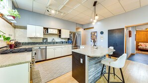 A modern kitchen with a central island, stainless steel appliances, and a bar area. - Long-term Stay in Milwaukee! Pet-friendly Condo (Milwaukee)