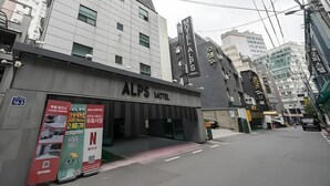 A modern building with a sign for ALPS HOTEL. It features a flat facade with large windows and a prominent entrance. - Alps motel (Incheon)
