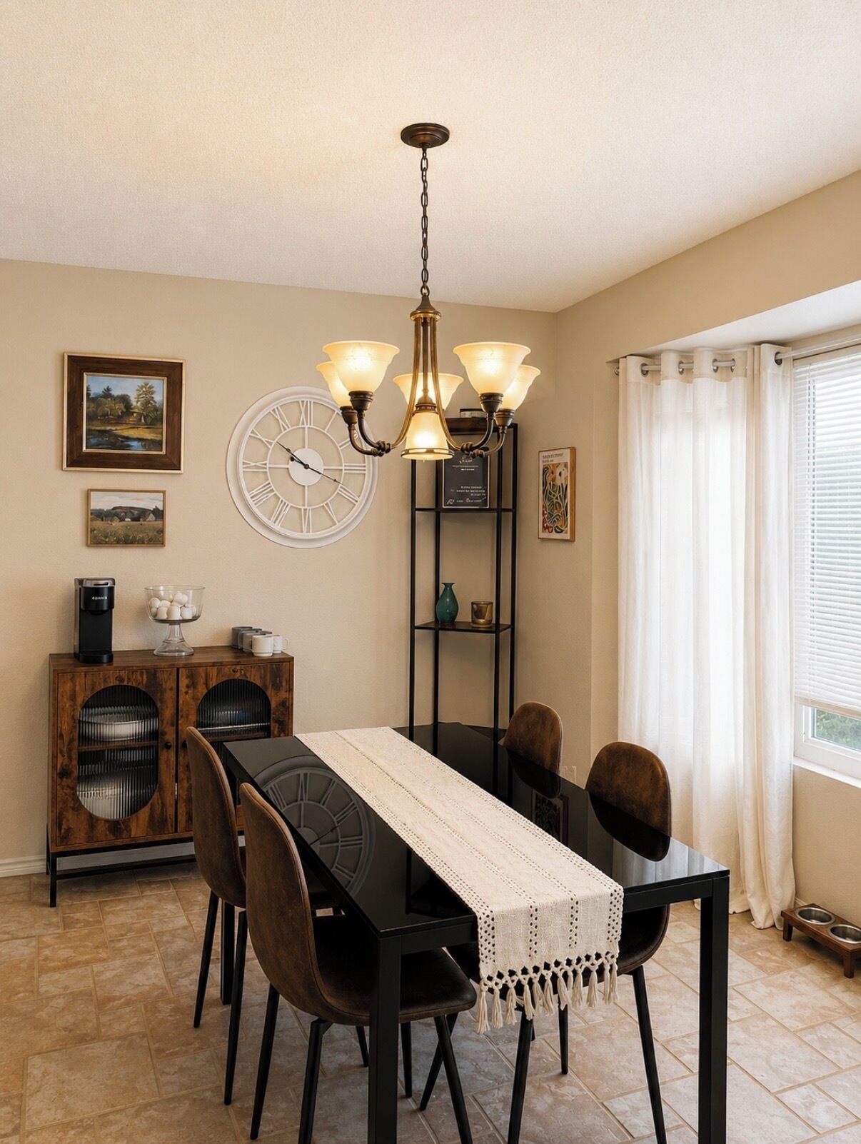 A dining area with a black table, chairs, a chandelier, a clock, and a cabinet with a coffee machine.