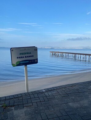 A sign indicating a private beach area. - Beachfront house with pool next to the Sesc Cacupe hotel. (Florianópolis)