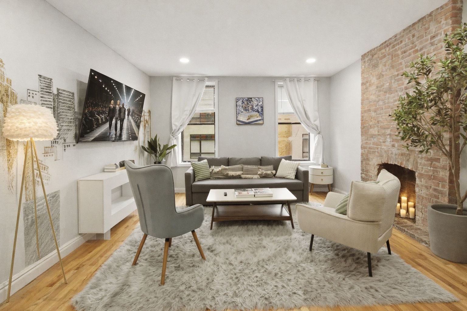 Een moderne woonkamer met een bank, twee fauteuils, een salontafel en een open haard.