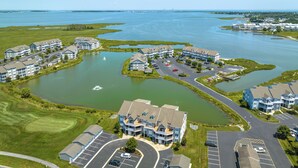 A residential area with multiple apartment buildings, a marina, and a golf course. - Bethany Bay Hideaway: Spacious, Modern 4 bed, 4 bath condo, water & wetland view (Ocean View)