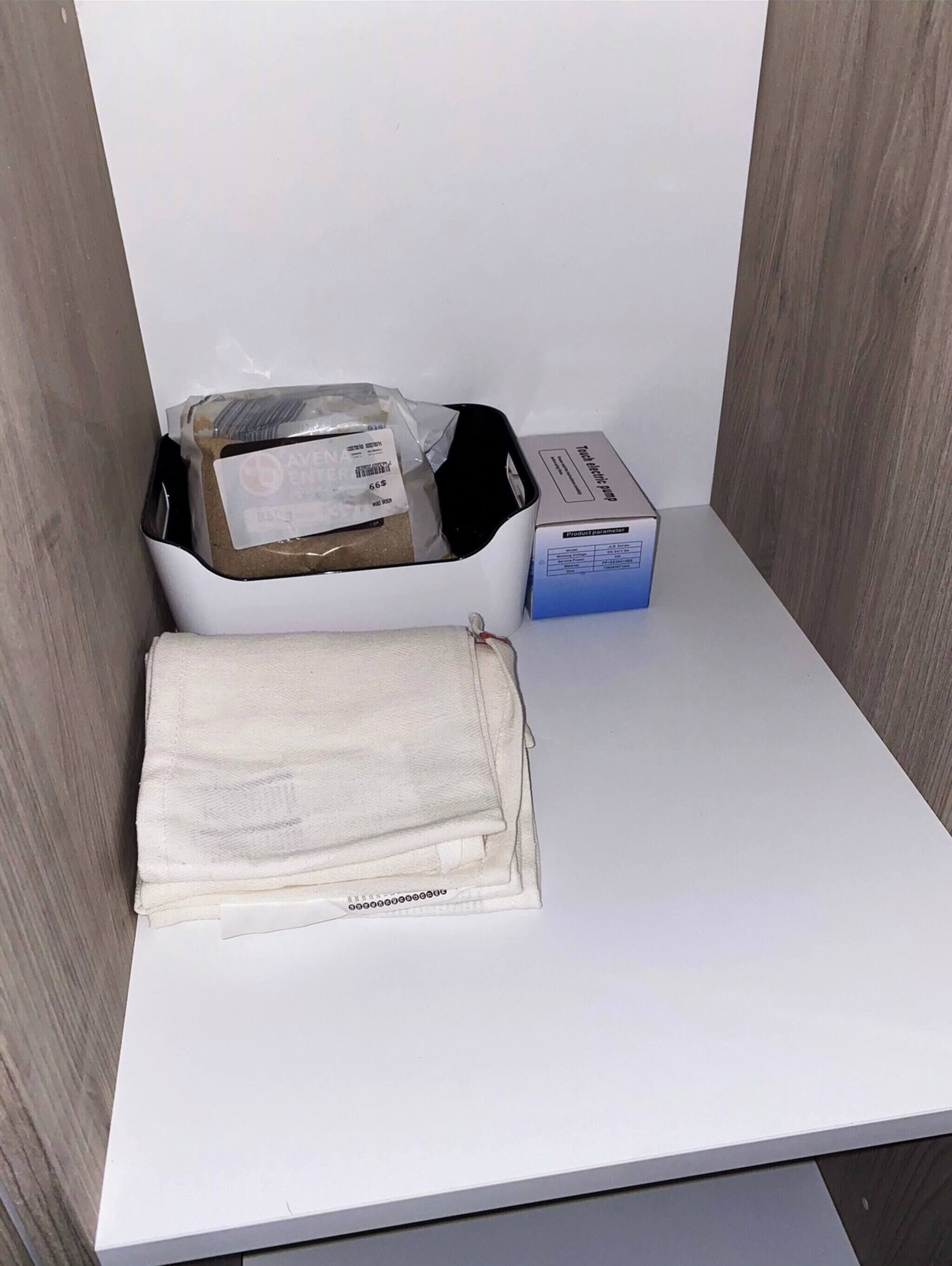 A white table with a box labeled "Product parameter" and a plastic bag containing a product.