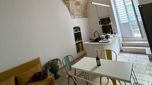 A modern kitchen with a white countertop, a sink, and a window with blinds. - [Casa Camelia] Elegant Palace with Terrace (Conversano)