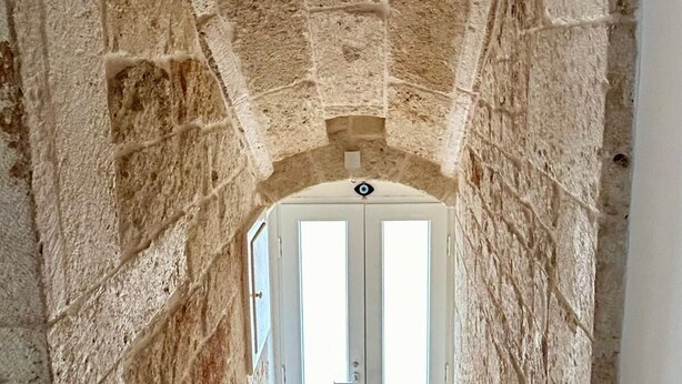 A stone staircase leading to a door with a window. - [Casa Camelia] Elegant Palace with Terrace (Conversano)