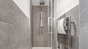 A modern shower with a glass enclosure, chrome fixtures, and a tiled floor. - Two bedroom loft in central Bristol (City of Bristol)