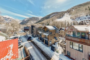 A modern building with a flat roof, large windows, and a balcony. - Luxury Downtown Home by InvitedHome | Bluegrass Fest, Walk to Shop/Hike, Balcony (Telluride)