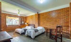 A room with two beds, a wooden table, and a chair. - Large 3-bedroom House in Penha Sel0068 (Penha)