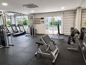 A gym with treadmills, weight machines, and dumbbells. - The Expression (Goiânia)
