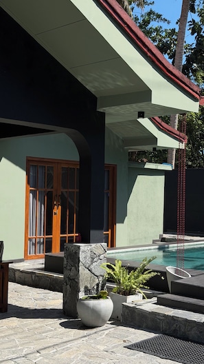 A modern building with a pool, stone steps, and a door with glass panels. - Delightful 3-bedroom Family house with AC in 5min walk by Kabalana beach. (Ahangama)