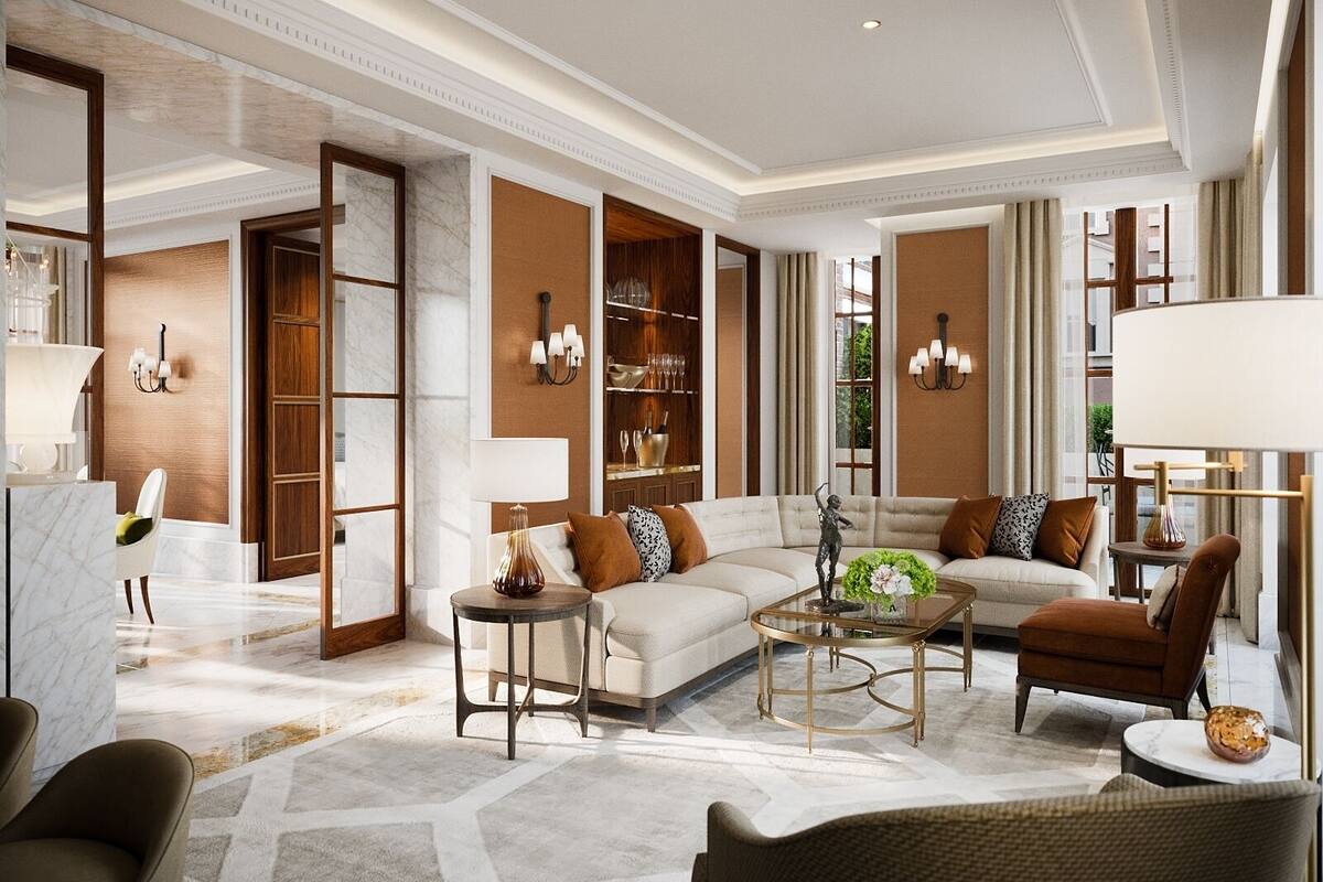 A spacious living room with a sofa, armchairs, a coffee table, and a fireplace.