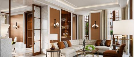 A spacious living room with a sofa, armchairs, a coffee table, and a fireplace.