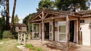 A wooden cabin with a porch, a small adjacent building, and a sign that reads "EPICERIE". - ZEcamping 4* animé piscine couverte locatif TV LV (Caro)