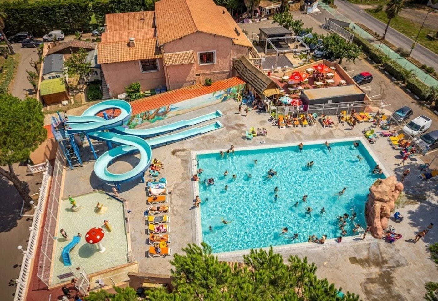 A water park with a large pool, slides, and a play area.