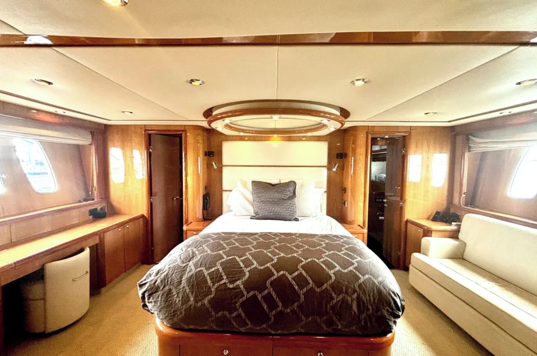 A spacious interior with a large bed, a desk, and a seating area.