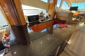 A compact kitchen area with a microwave, coffee maker, and blender on a countertop.