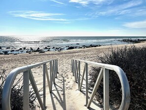 A beach pathway leading to the ocean with a metal railing. - Private Green Hill Retreat 3+ bedrooms  w/Private Beach Pass and AC (South Kingstown)