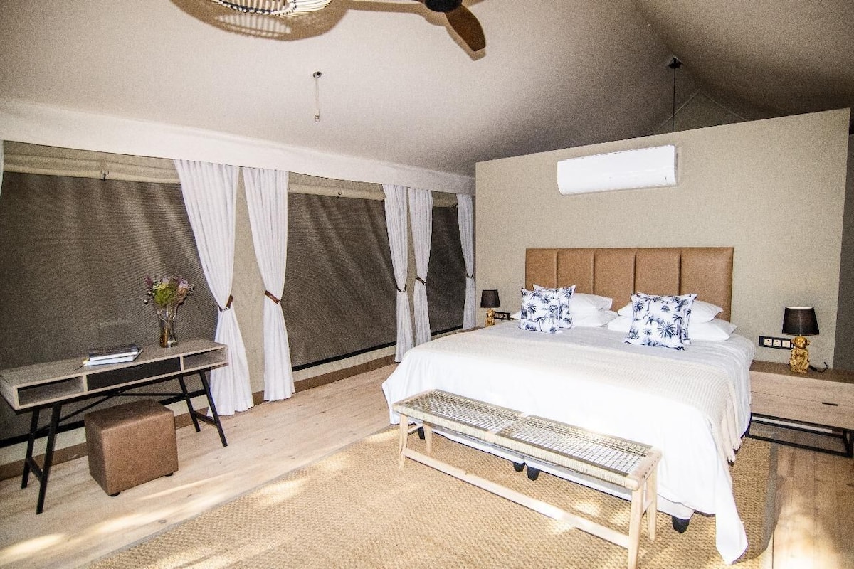 Una camera da letto con un letto grande, una scrivania e una sedia.