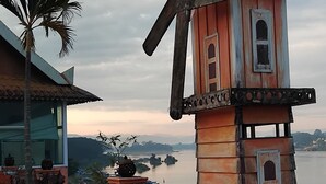 A rustic windmill structure with a view of a body of water and distant islands. - Houayxai Riverside Phonevichith Hotel (Houayxay)