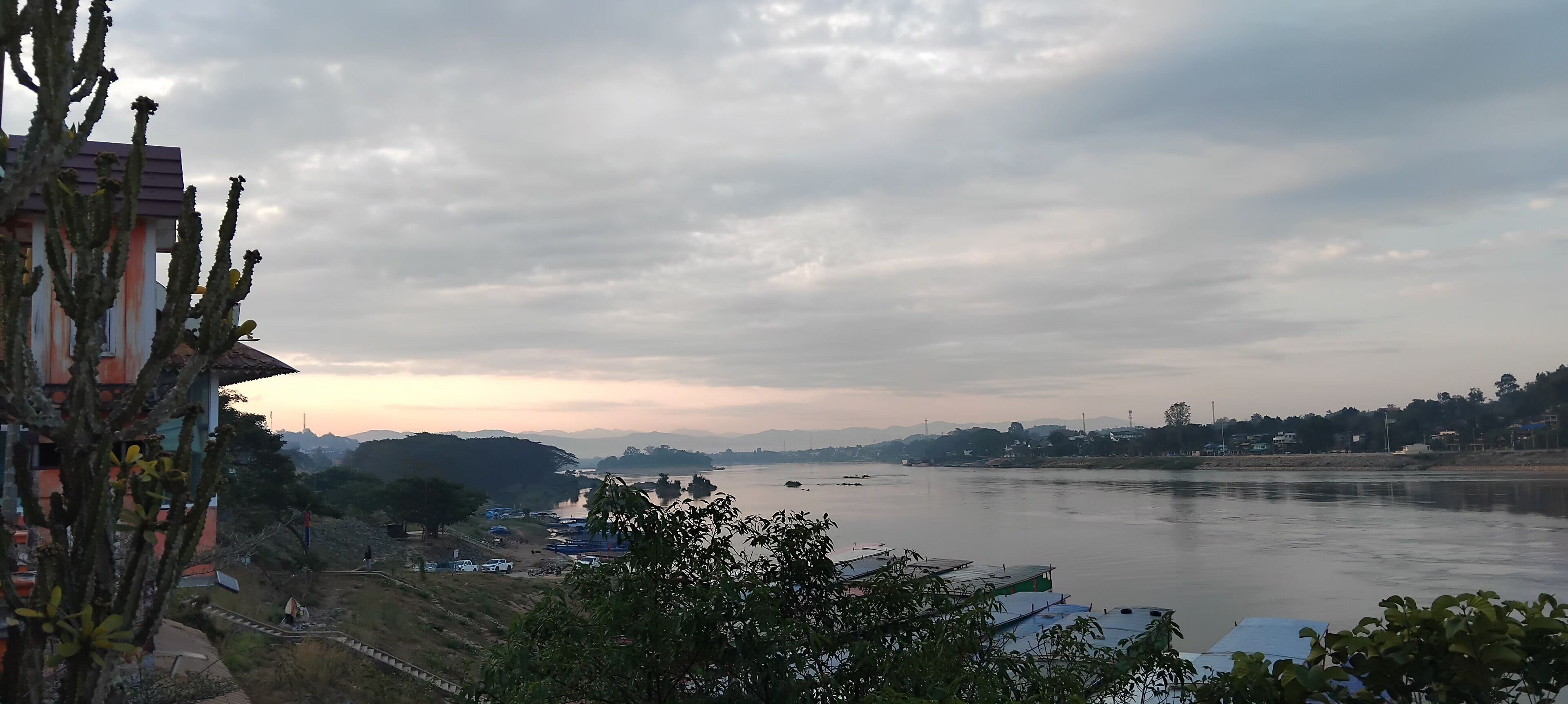 A river with boats, a bridge, and buildings in the background.
