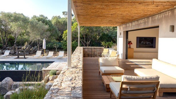 A modern outdoor lounge area with a pool, wooden deck, and seating. - Contemporary sea-view villa with large infinity pool and walking distance to the beach (Zonza)