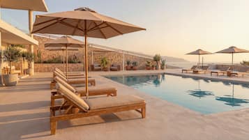 Seasonal outdoor pool, open 9:00 AM to 7:00 PM, pool umbrellas