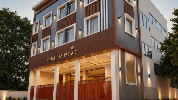 A multi-story hotel with a modern facade, large windows, and a prominent entrance. - Hotel KS Palace (Sarnath)