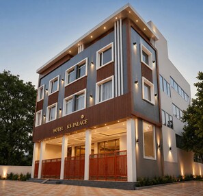 A multi-story hotel with a modern facade, large windows, and a prominent entrance. - Hotel KS Palace (Sarnath)