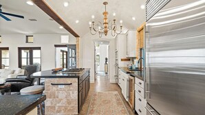 A modern kitchen with a large island, stainless steel appliances, and a chandelier. - ☀️Private pool | Luxury | Golf Cart | 6 Bikes | Villa Tranquility☀️ (Destin)