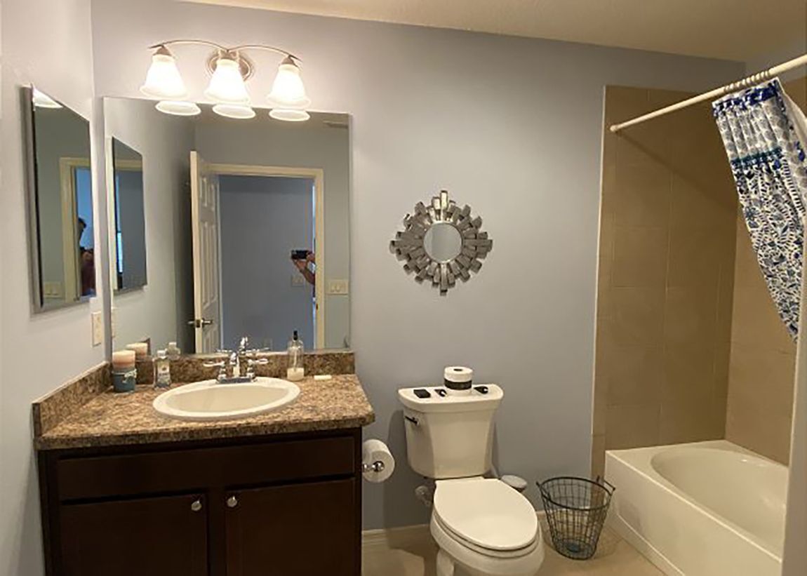 A bathroom with a sink, toilet, and bathtub.