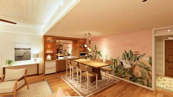 A modern kitchen with wooden cabinets, a dining table, and chairs. There is a large window with a view of the water.