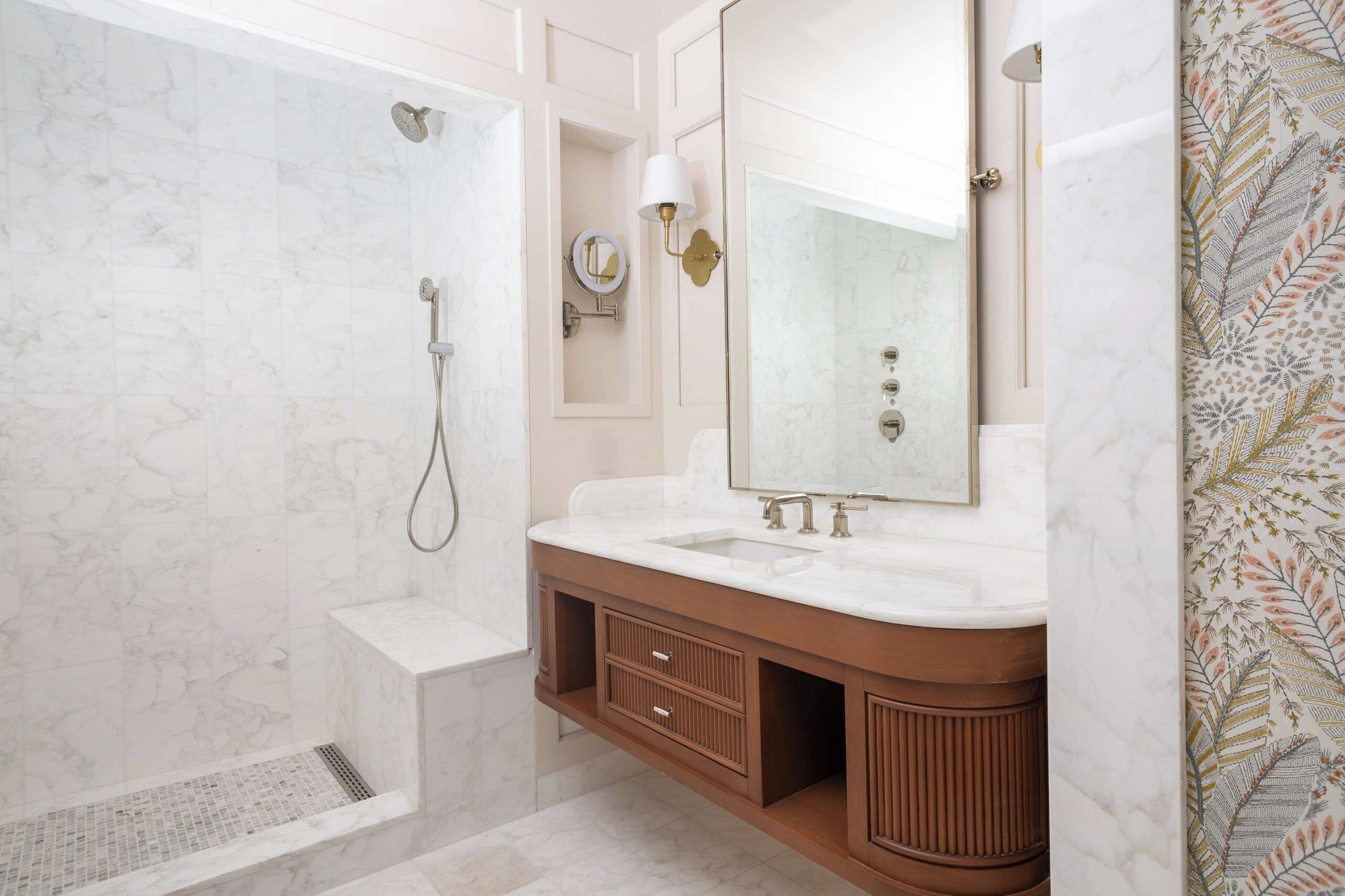 A bathroom with a shower, vanity, and a large mirror.