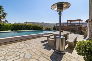 A pool area with stone flooring, a pergola, and a metal heater. - Holiday Home 'Quinta do Rio Douro - Rural Tourism' with Mountain View, Pool and AC (Douro)